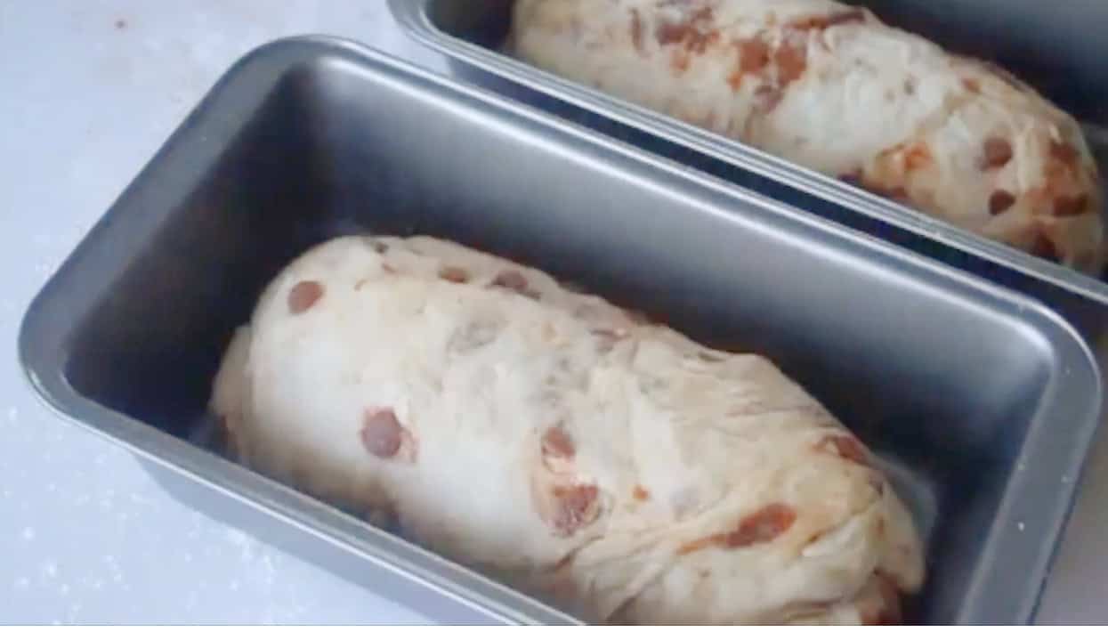 Bread pans with unbaked bread dough inside.