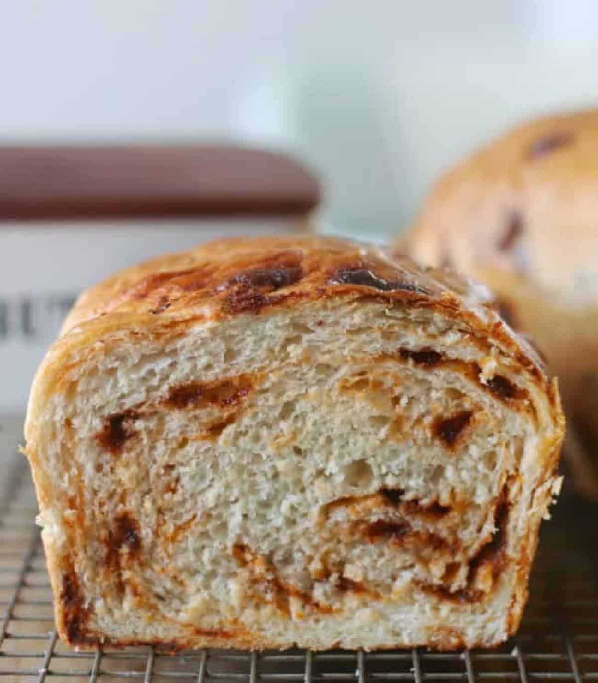 Loaf of cinnamon bread with slice cut from it.
