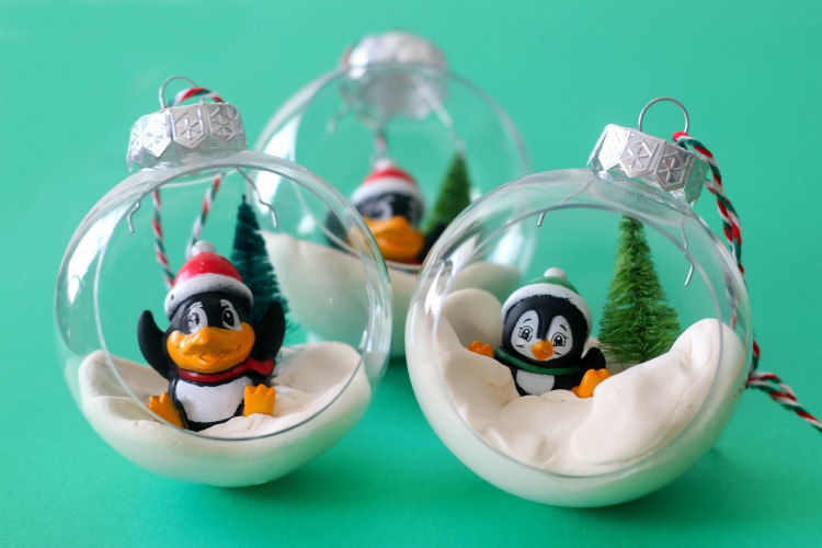 3 penguin ornaments on green backdrop