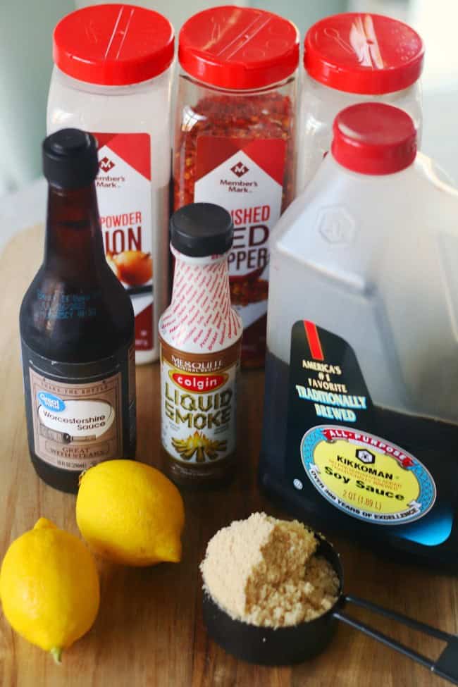 Lemons, brown sugar, bottle of soy sauce, Worcestershire sauce, liquid smoke, bottles of garlic powder, onion powder and red pepper flakes.