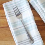 cloth napkin folded with fork on top