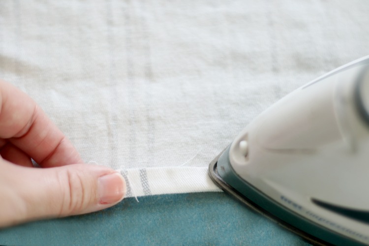 edge of fabric being ironed