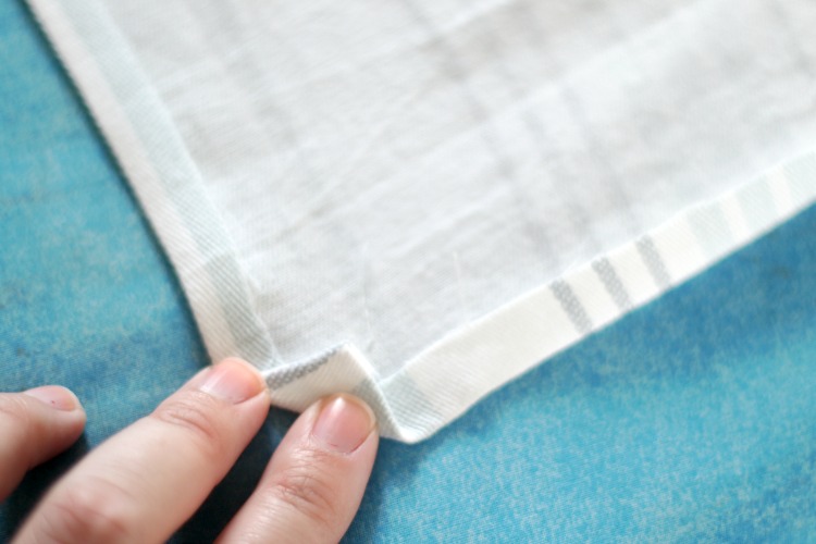 corner on fabric folded over for hem on cloth napkin