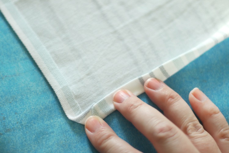 edge of fabric folded over for hem on cloth napkin