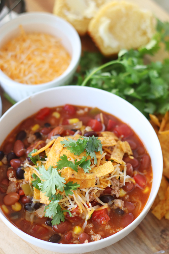 bowl of slow cooker taco soup with cilantro and cheese on top