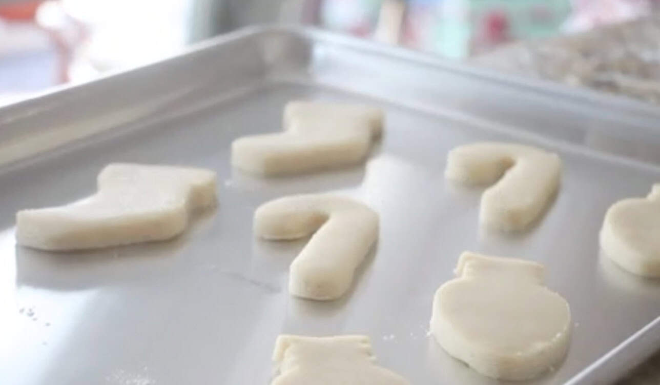 Cut out cookies on metal baking pan.