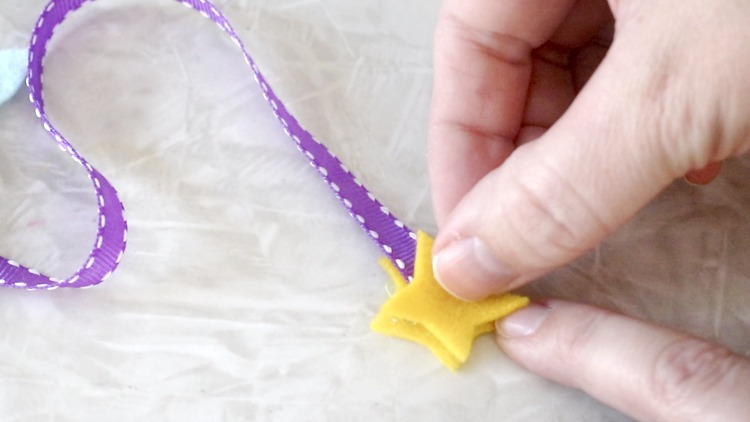 gluing star to the bottom of ribbon on narwhal bookmark