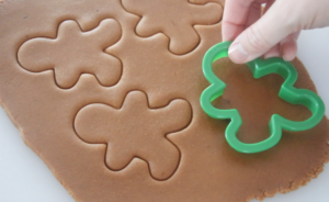 quick gingerbread cookie dough rolled out and cut out with cookie cutters