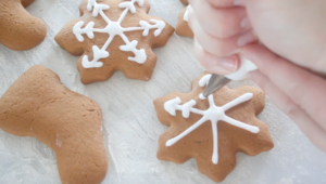 hand piping icing on quick gingerbread cookies