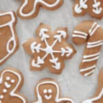 Cutout gingerbread cookeis iced with white outlines.