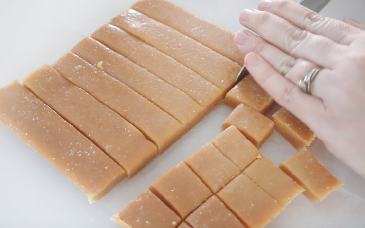 hand cutting caramels into squares