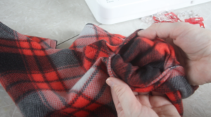hands turning scarf right side out