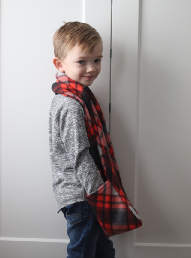 little boy wearing red and black pocket scarf
