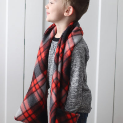 little boys with red and black pocket scarf around neck
