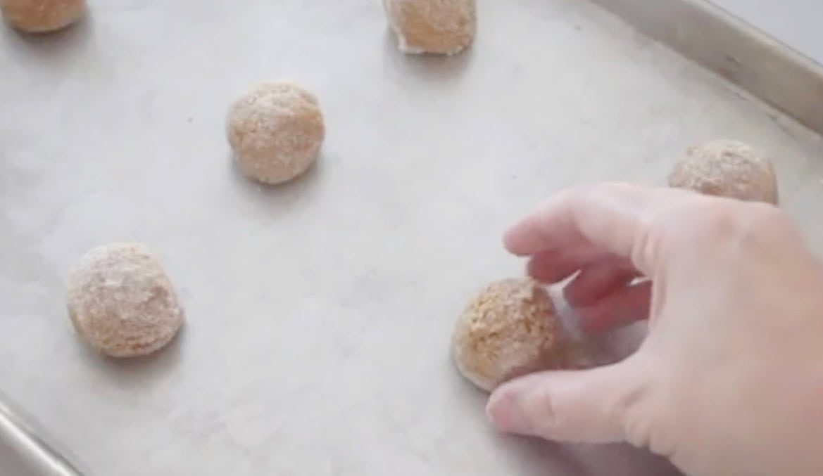Ginger cookie dough balls on baking sheet.