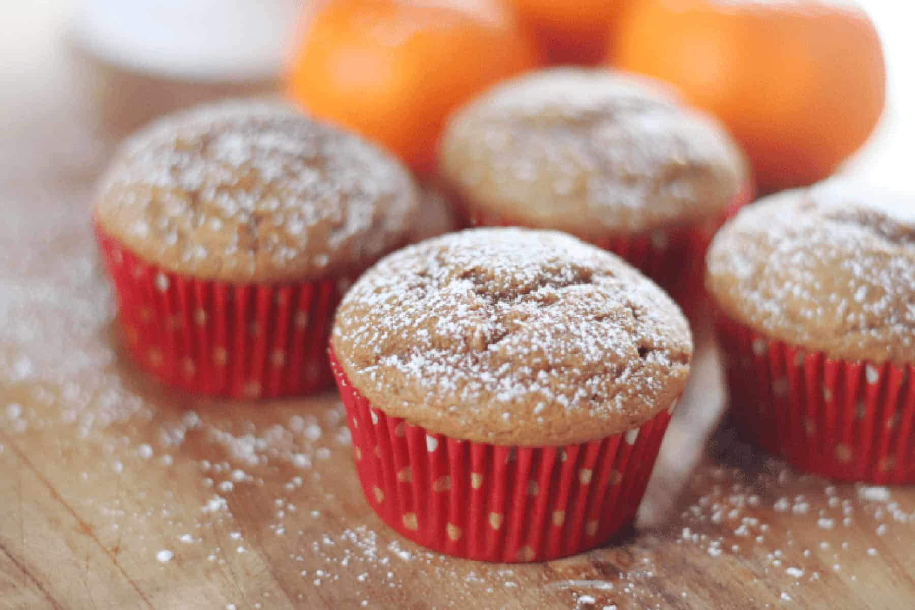 Gingerbread muffins in red muffin liners.