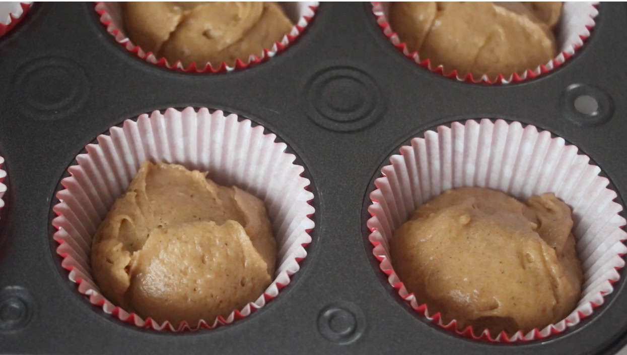 Unbaked muffins in muffin pan.