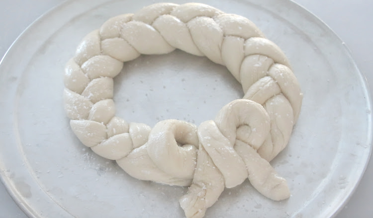 unbaked pretzel wreath on greased baking sheet