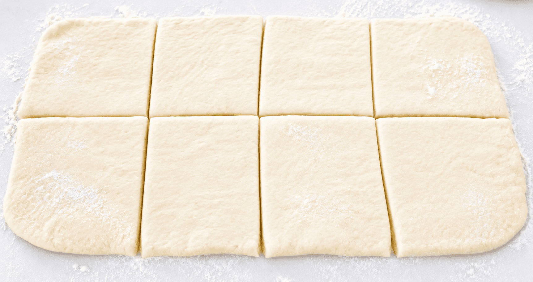Croissant dough rolled and cut into 8 squares.