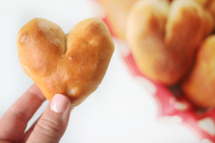 hand holding heart shaped roll