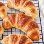 Croissants on a wire cooling rack.