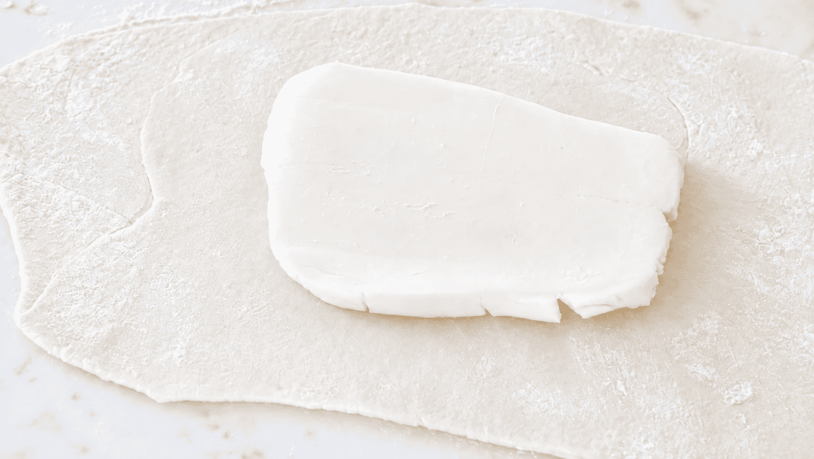 Dough rolled out with butter in center.