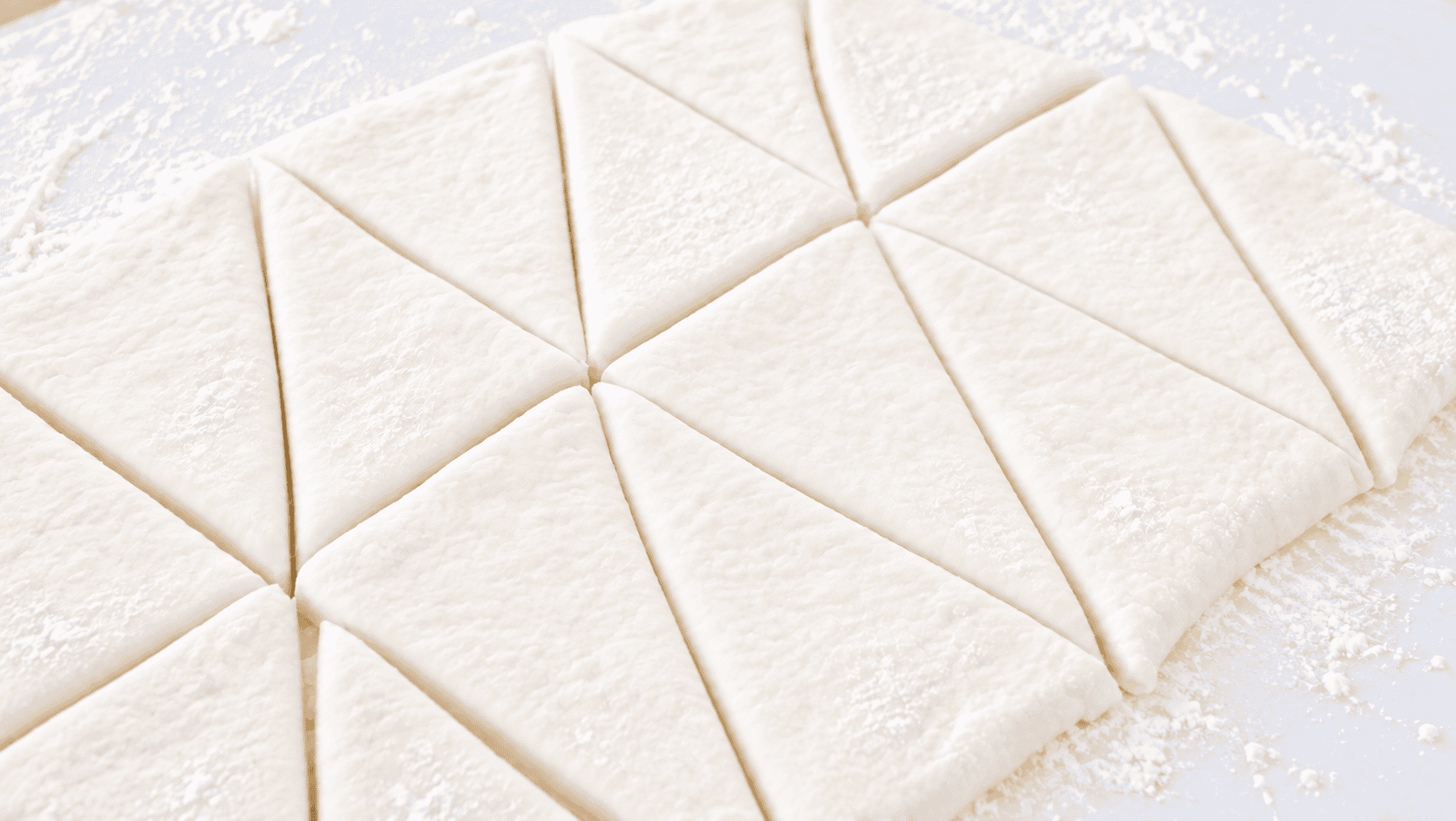 Croissant dough cut into triangles.