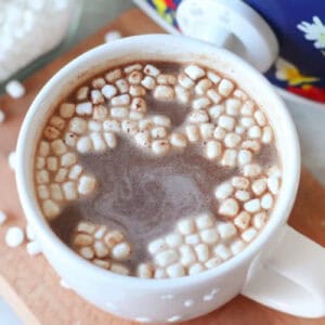 White mug of slow cooker hot chocolate with mini marshmallows.