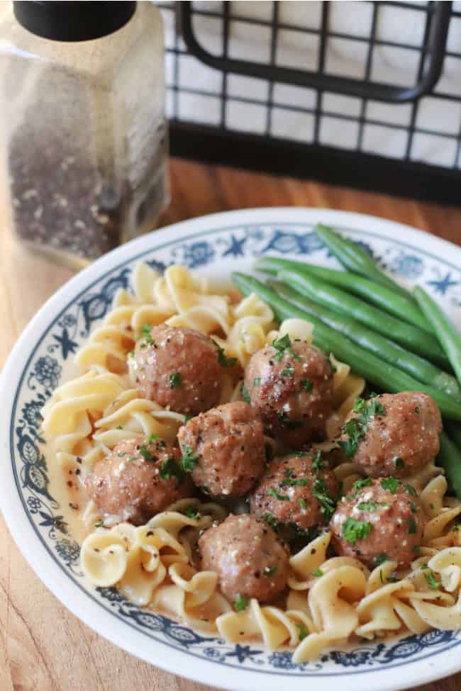 meatballs with sauce over egg noodles on plate