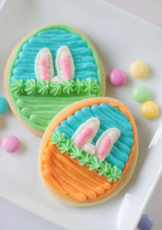 two easter basket sugar cookies on a white plate