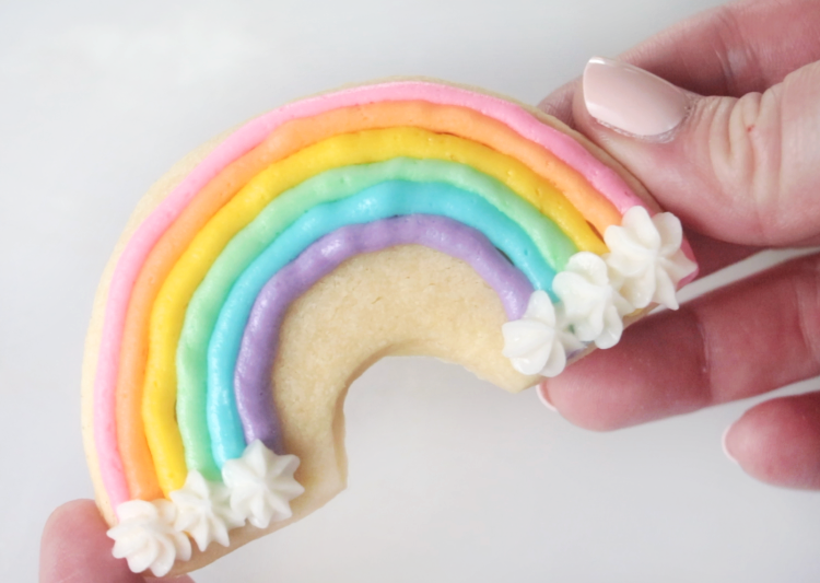 hand holding rainbow sugar cookie