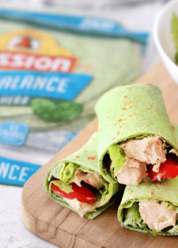 3 caesar salad rolls ups on cutting board