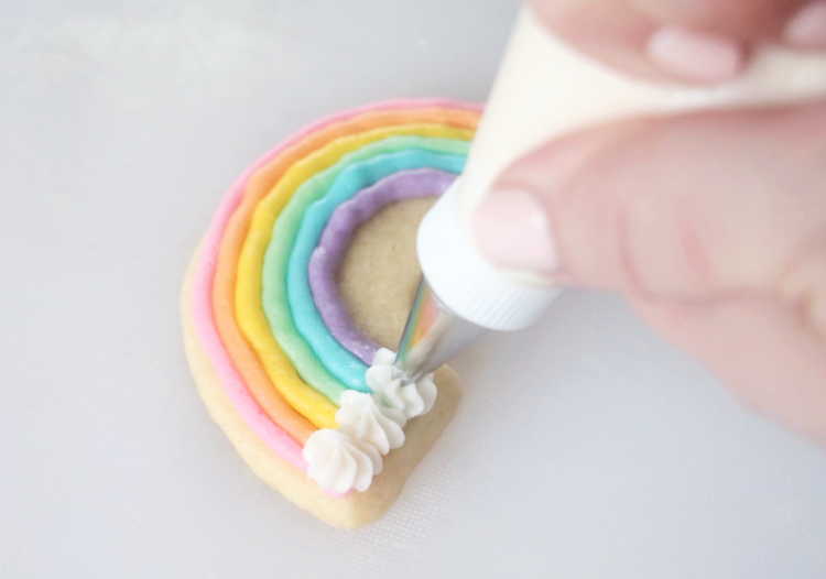 rainbow cookie with colorful frosting and white could frosting