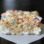 Large rice krispies treat on parchment paper.