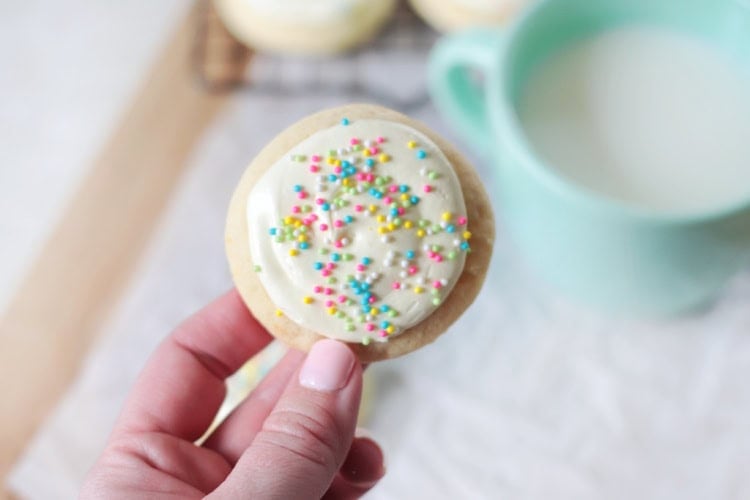 Hand holding sugar cookie.