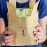 Girl holding brown bunny bag.