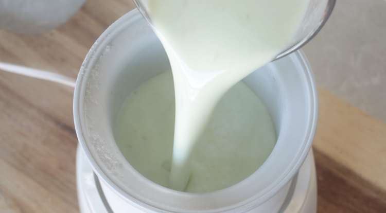 lime ice cream batter being poured into ice cream maker