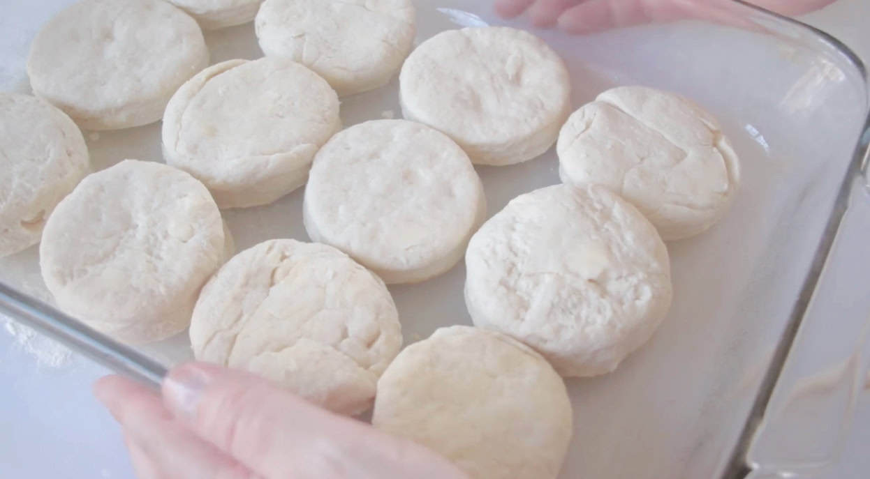 Baking dish with 12 unbaked biscuits.