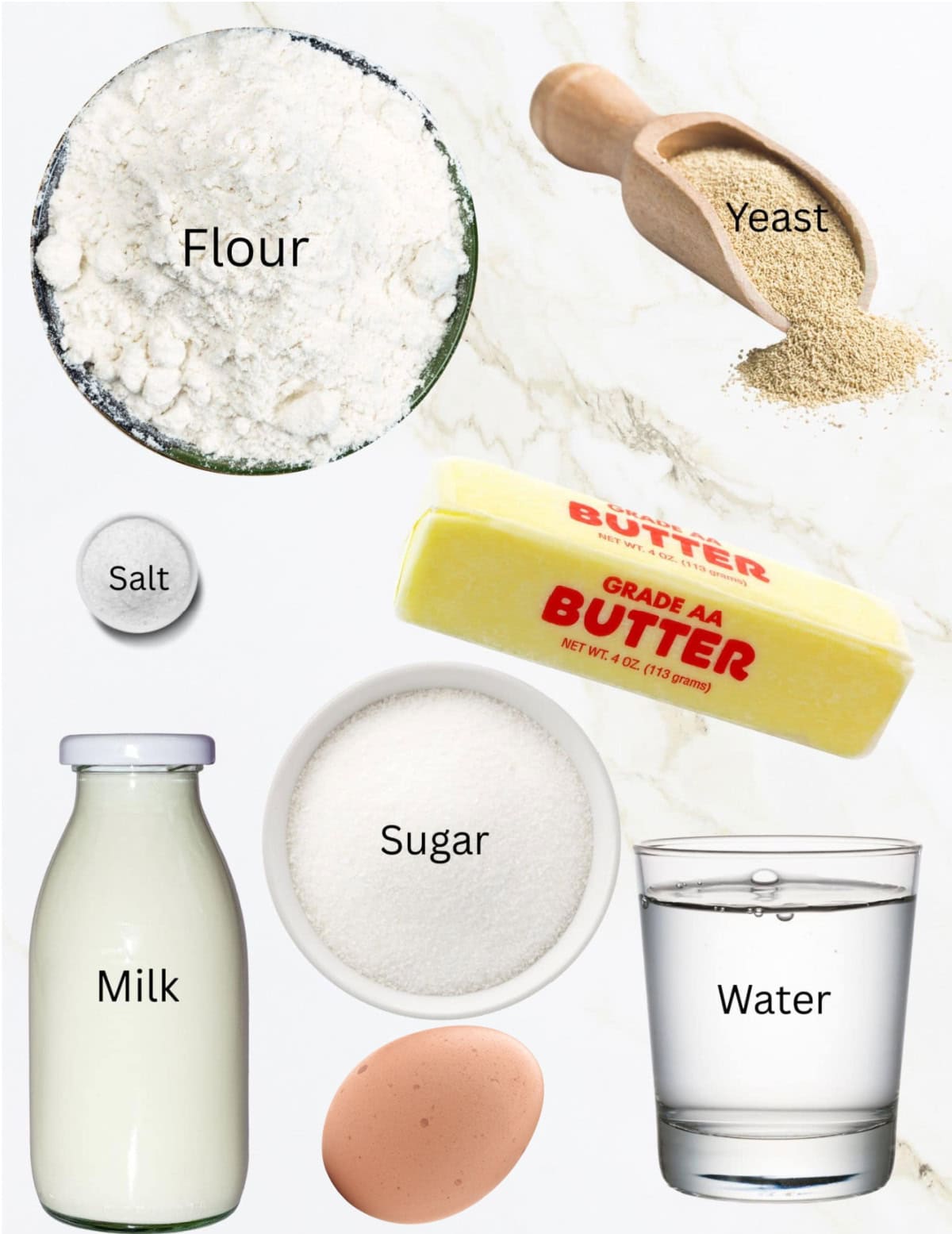 Bowls of flour, salt, sugar, bottle of milk, egg, water, stick of butter and scoop of yeast.