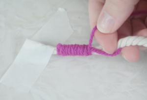 purple yarn wrapped around rope