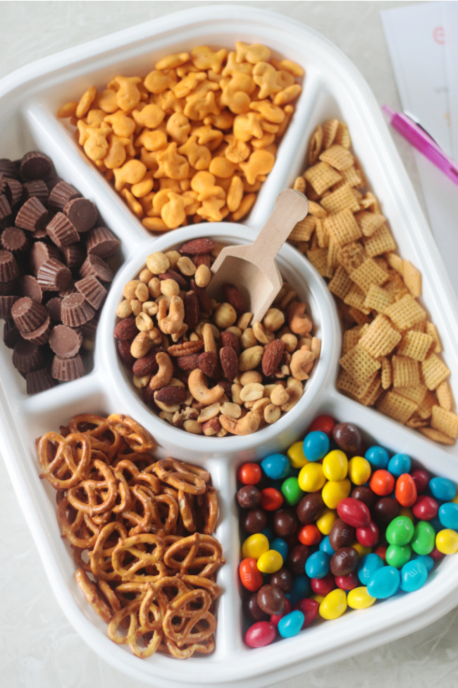 divided tray with pretzels, nuts, candy and crackers