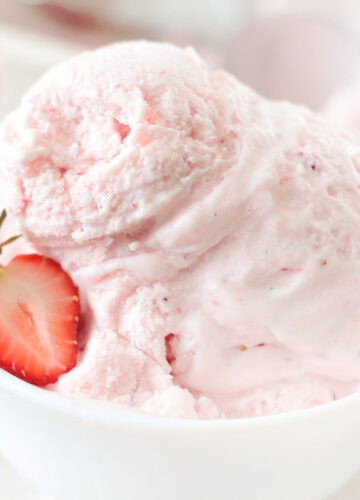white bowl with two scoops of strawberry ice cream