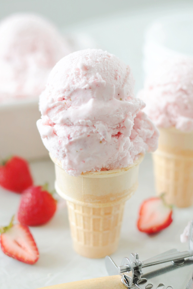 ice cream cone with two scoops of strawberry ice cream