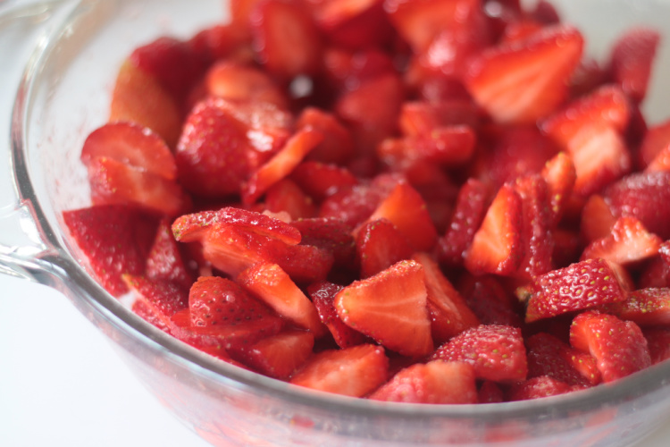 bowl of sliced strawberries and sugar