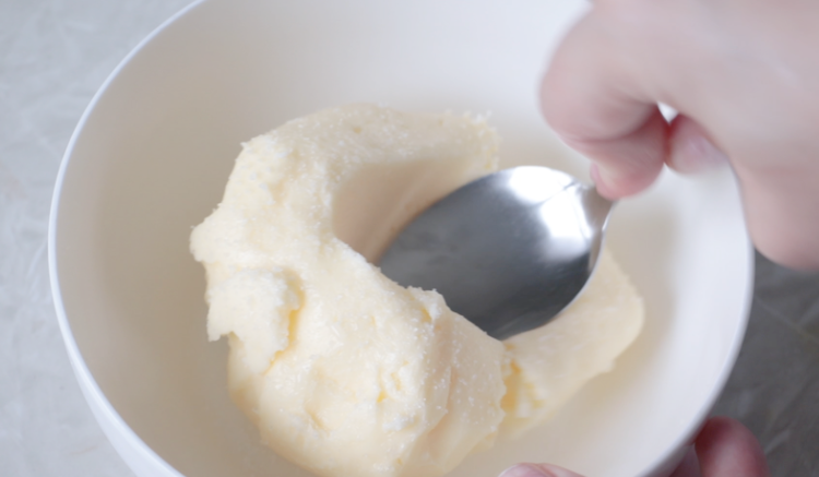 butter in bowl mixing salt in with a spoon