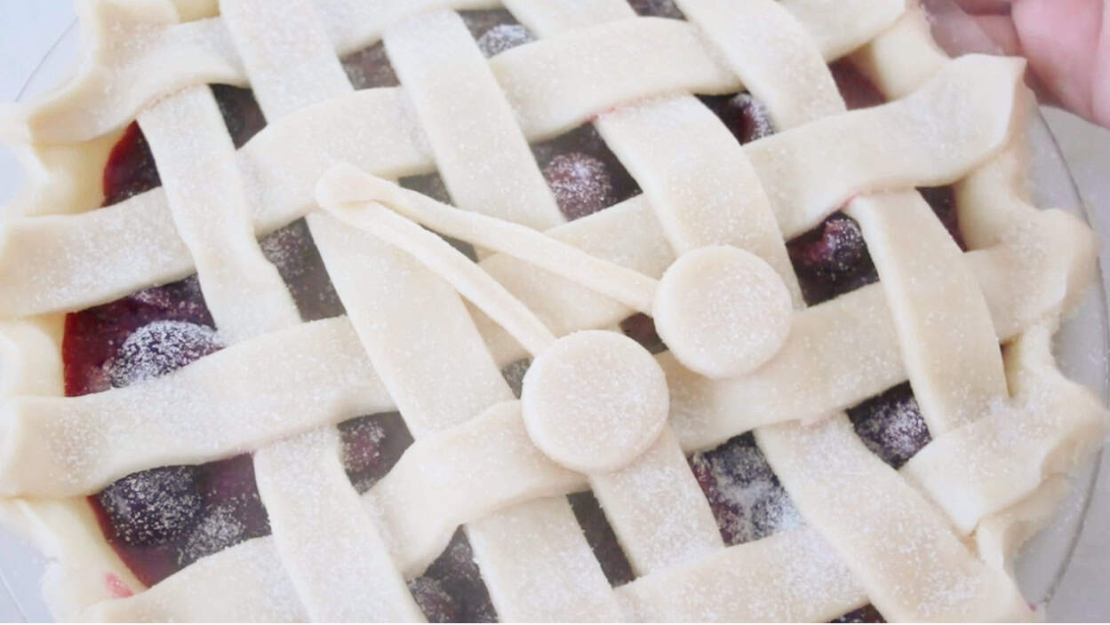Unbaked cherry lattice pie.