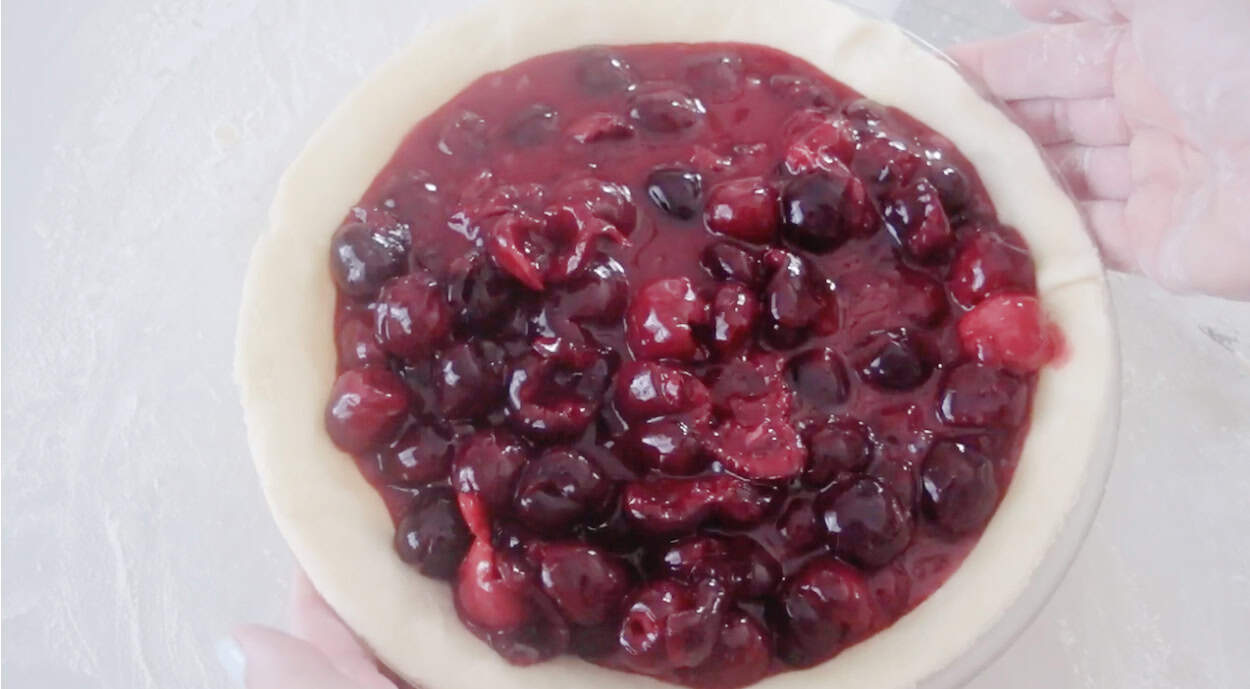 Cherry pie filling inside pie crust.