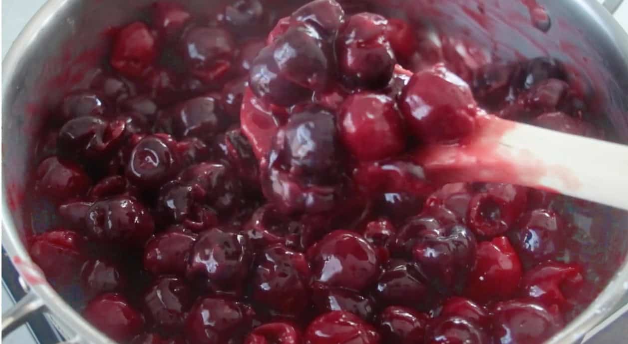 Homemade cherry pie filling in saucepan.