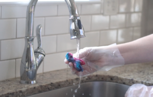 hand rinsing scrunchies under faucet