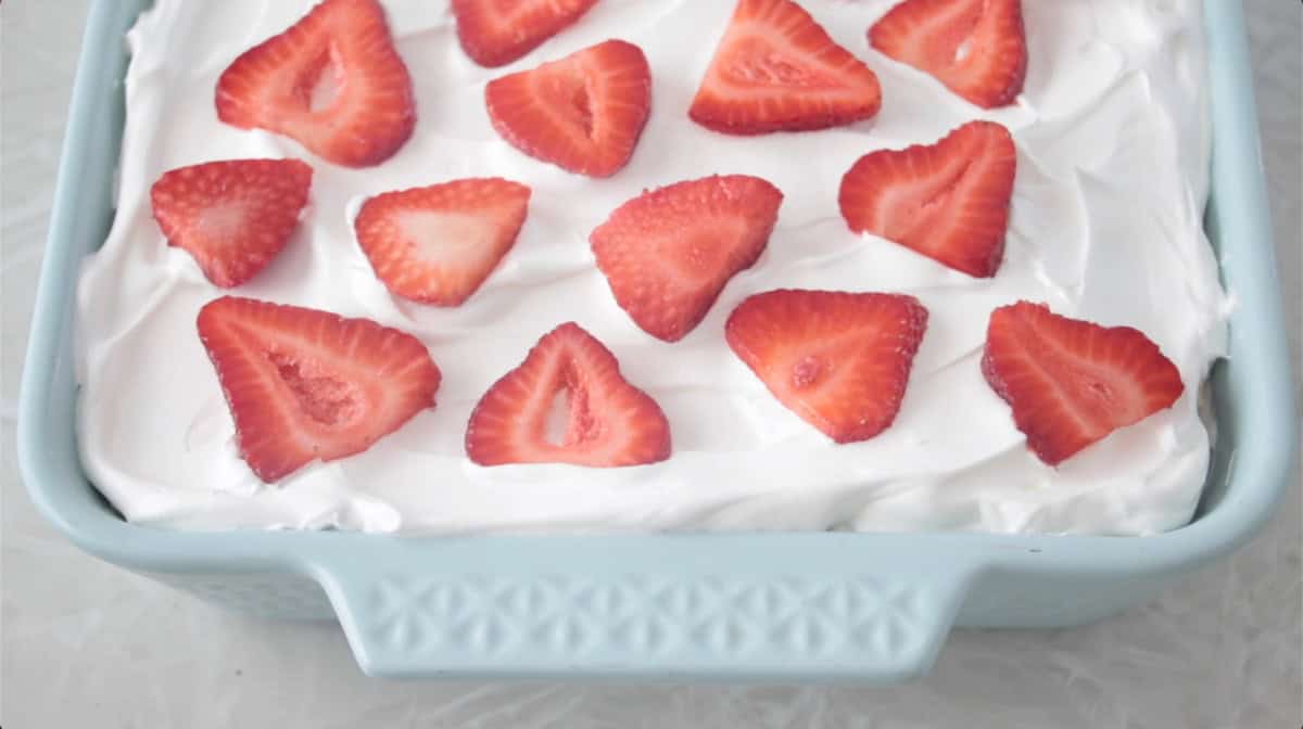 Fresh strawberries on top of ice box cake.